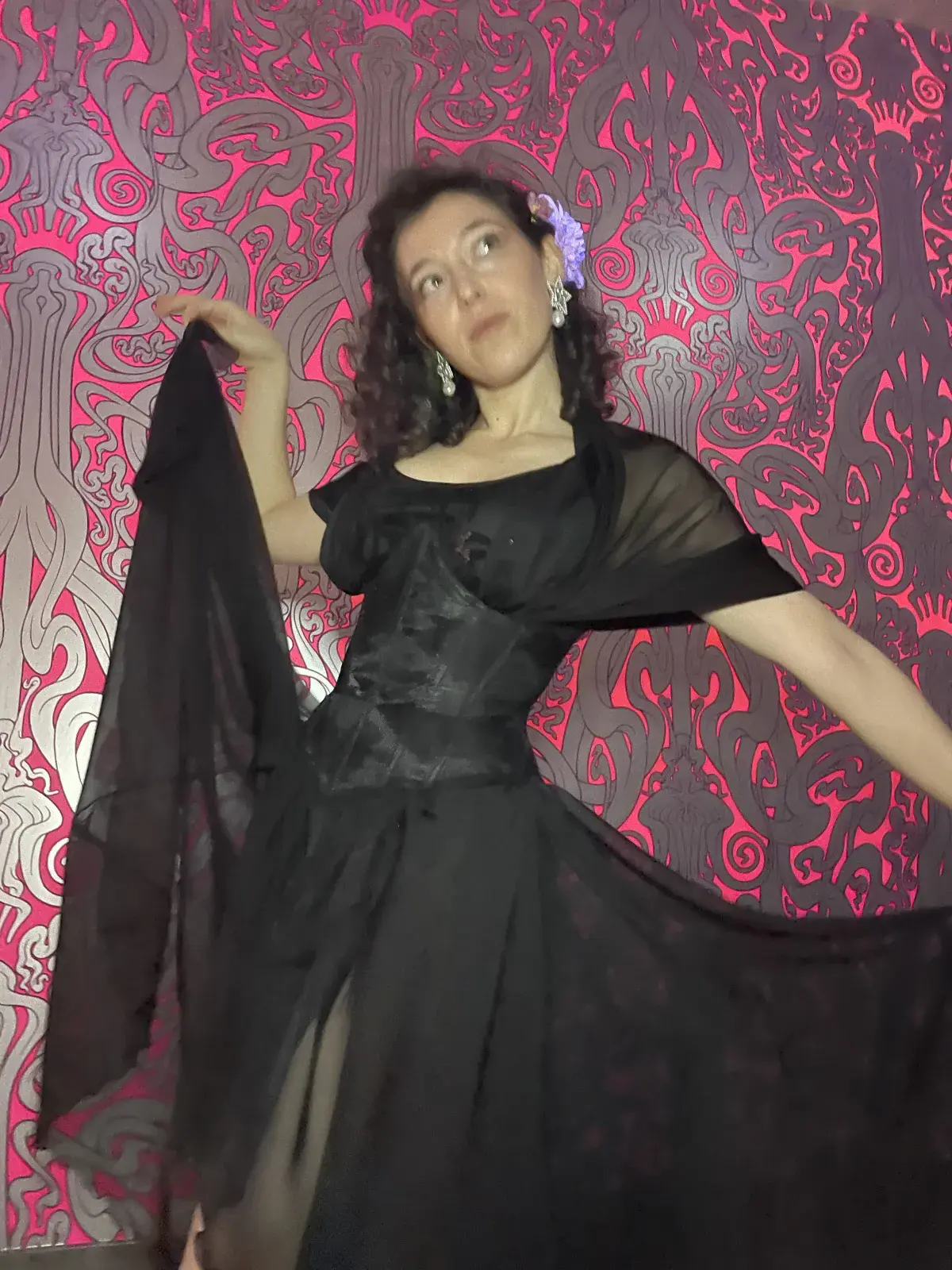 Dashiell demonstrates a pole move in her black wedding dance outfit.