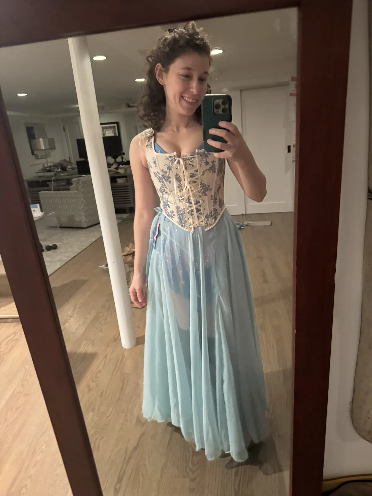 Mirror selfie wearing a pale blue corset with a long light blue skirt.